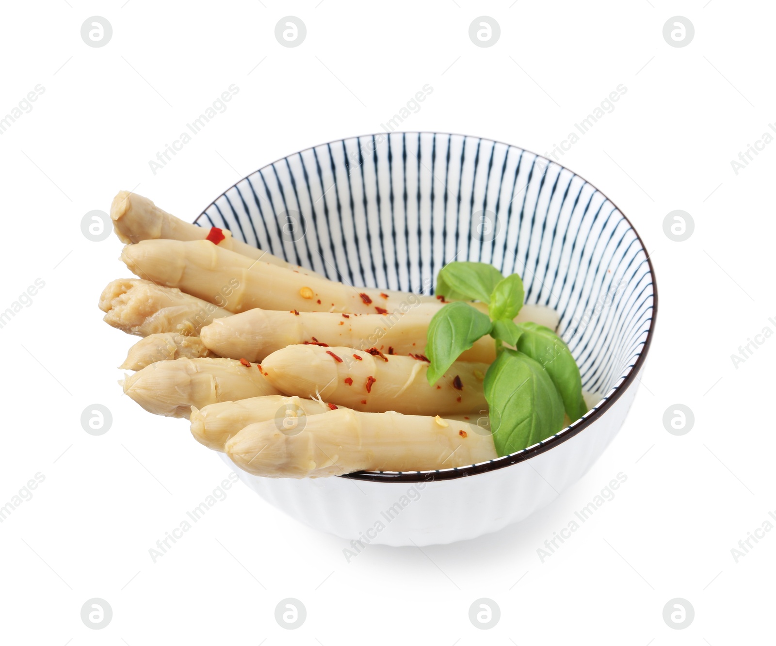 Pickled asparagus spears with spices and basil isolated on white Photo of Pickled asparagus spears with spices and basil isolated on white