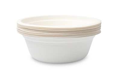Photo of Disposable tableware. Stack of paper bowls isolated on white