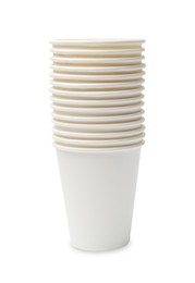 Photo of Disposable tableware. Stack of paper cups isolated on white