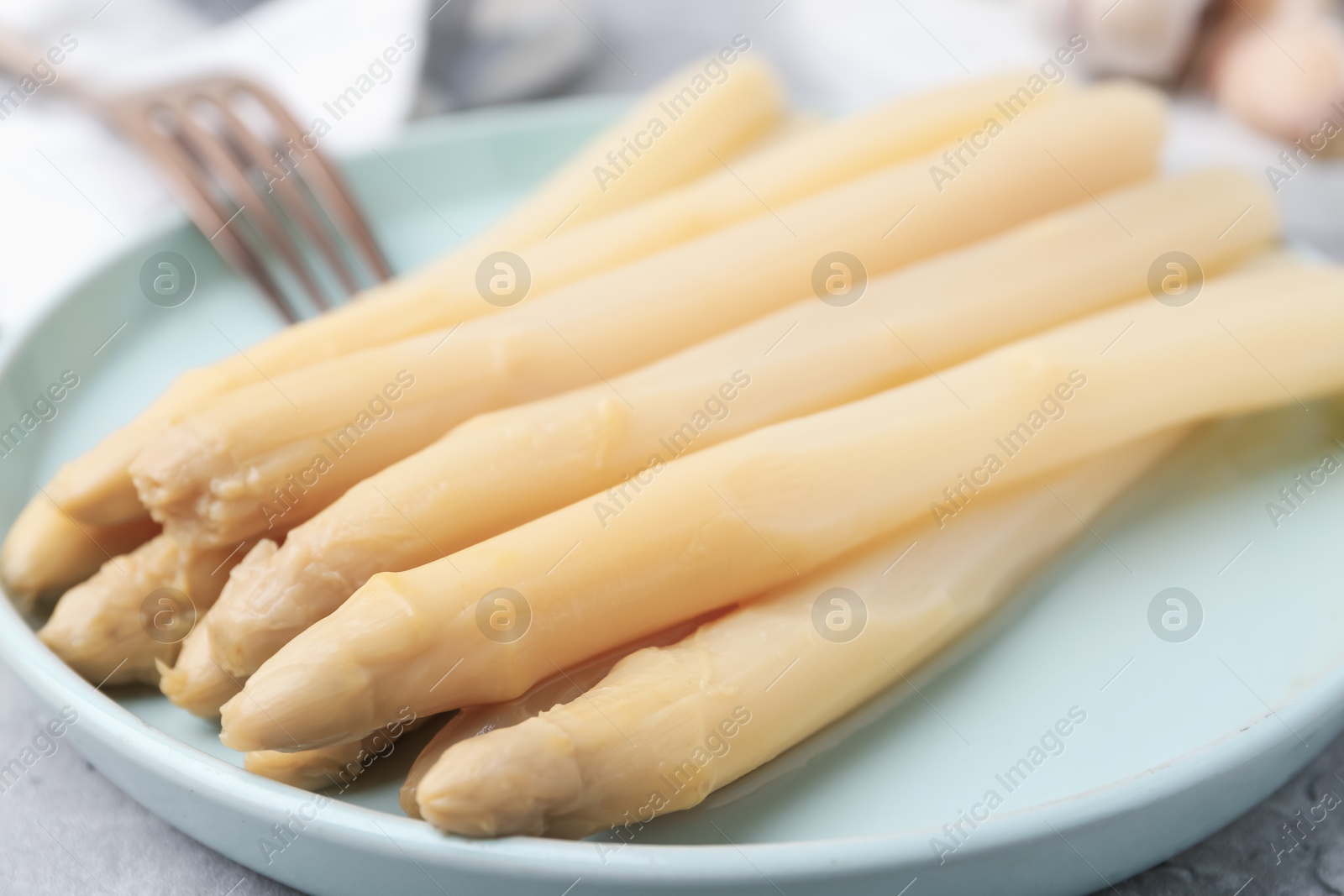 Photo of Pickled asparagus spears served on table, closeup