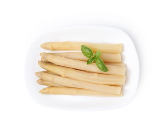 Photo of Pickled asparagus spears with basil isolated on white, top view
