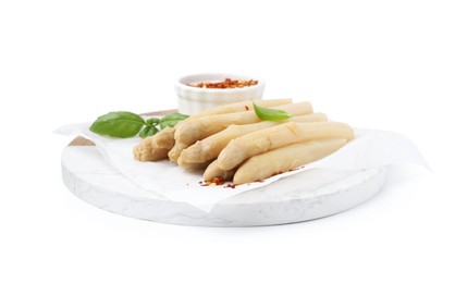 Photo of Pickled asparagus spears with spices and basil isolated on white