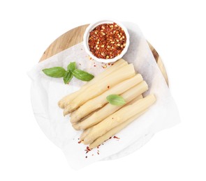 Photo of Pickled asparagus spears with spices and basil isolated on white, top view