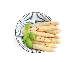 Photo of Pickled asparagus spears with spices and basil isolated on white, top view