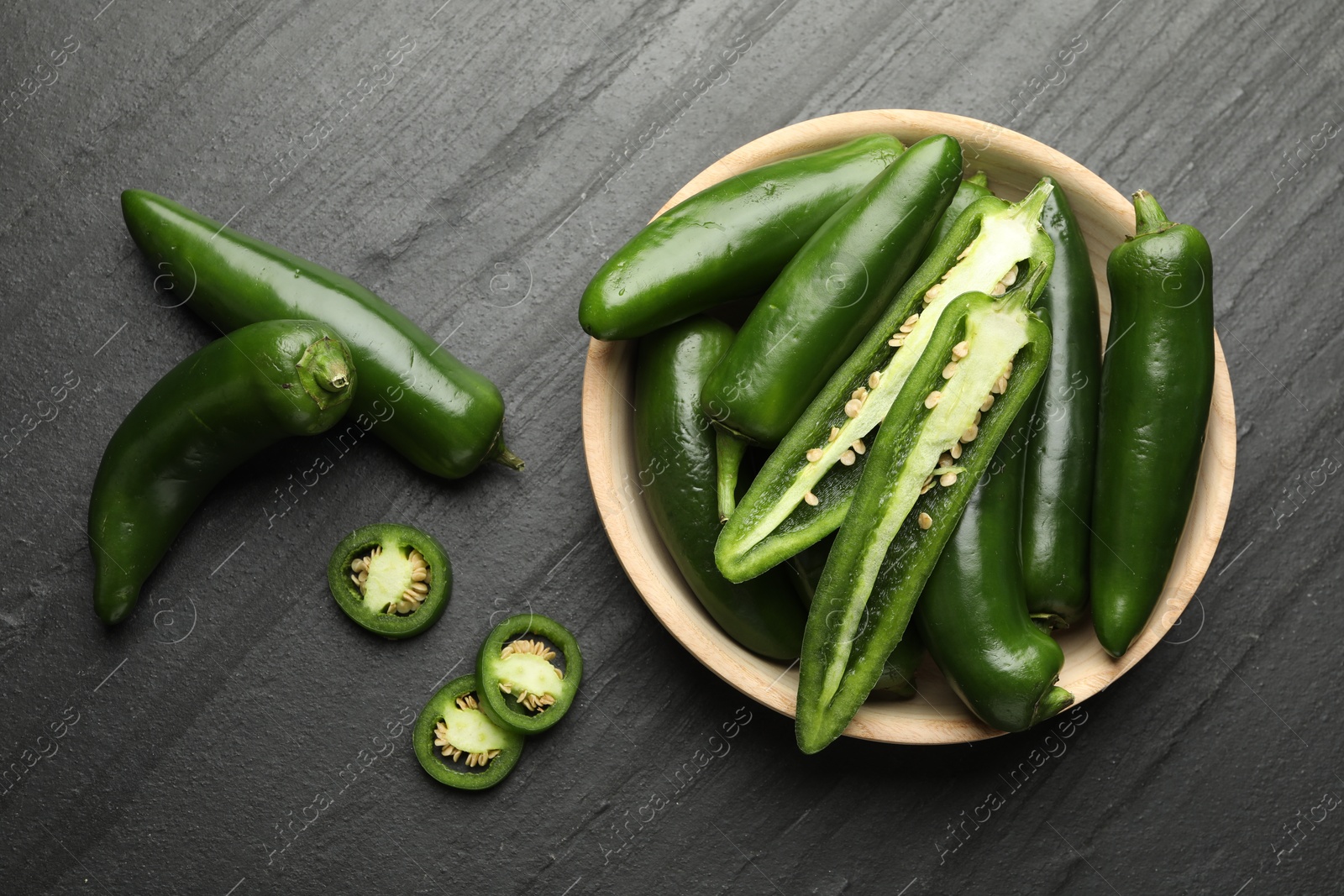 Photo of Ripe green jalapeno peppers on grey table, flat lay