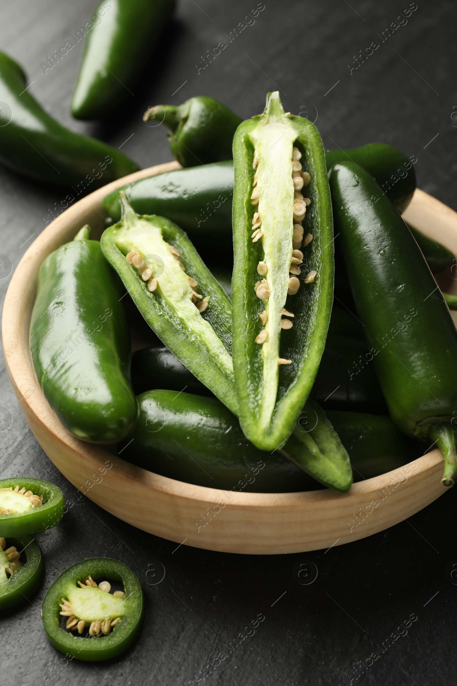 Photo of Ripe green jalapeno peppers on grey table, closeup