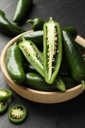 Photo of Ripe green jalapeno peppers on grey table, closeup