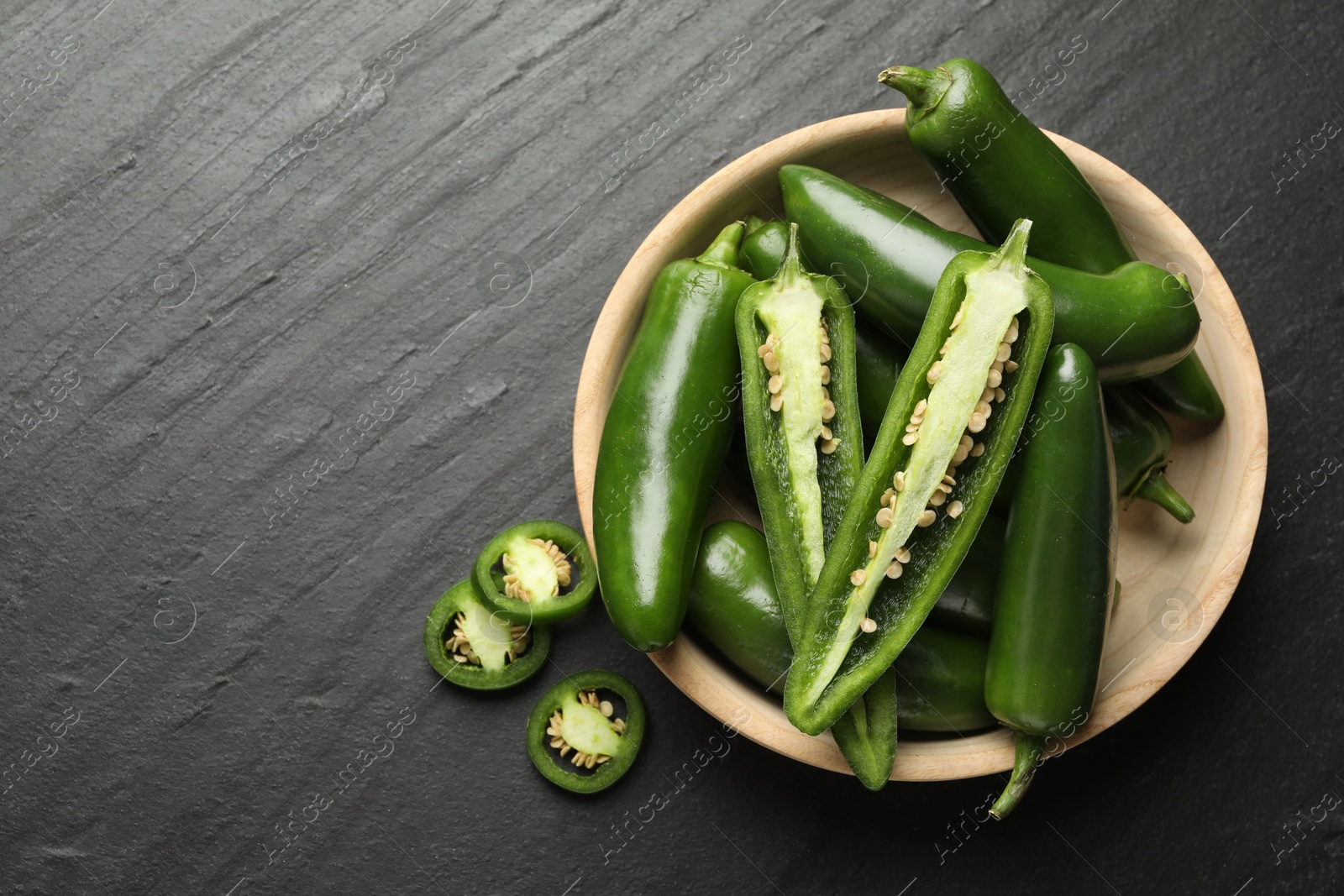Photo of Ripe green jalapeno peppers on grey table, flat lay. Space for text