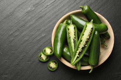 Photo of Ripe green jalapeno peppers on grey table, flat lay. Space for text