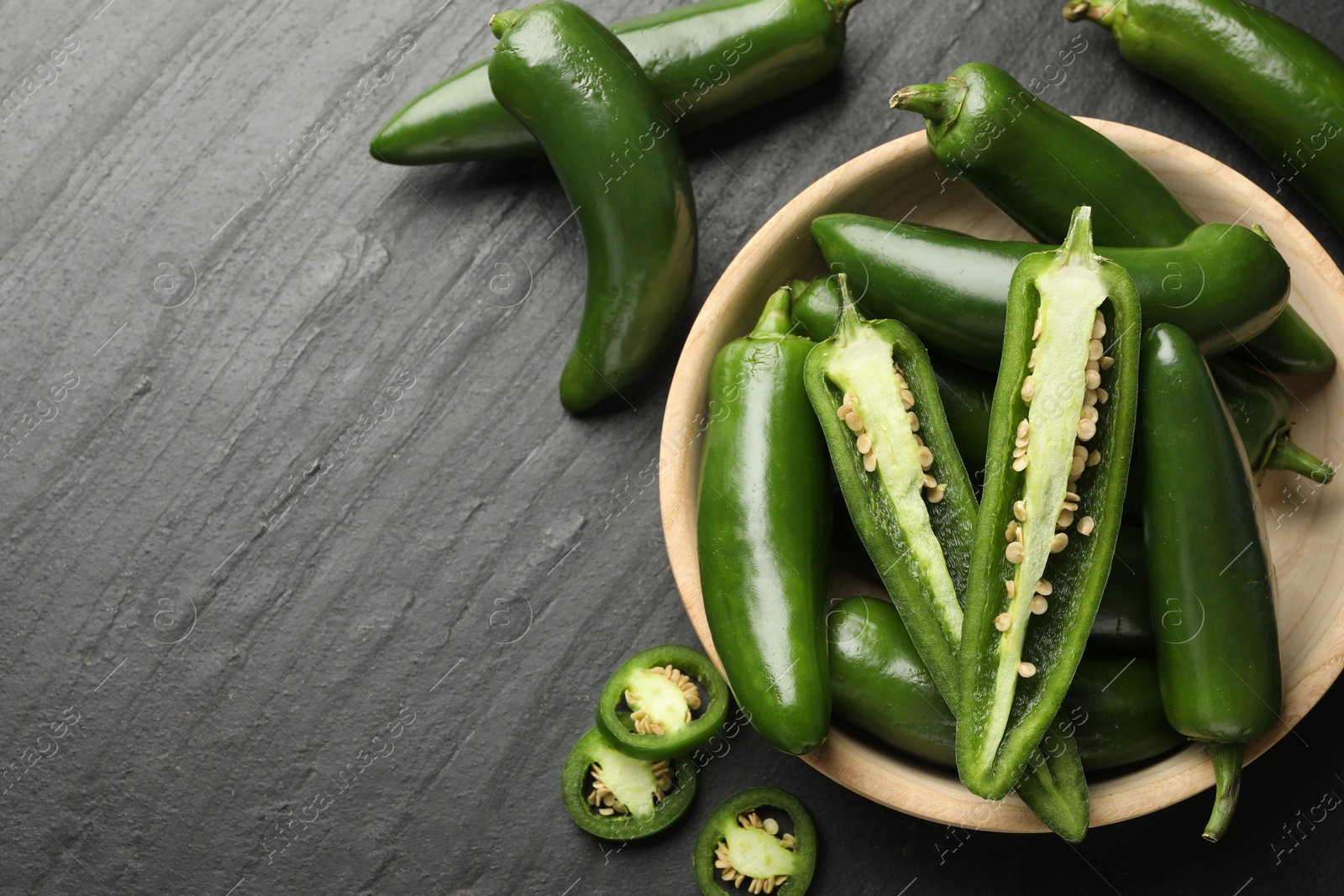 Photo of Ripe green jalapeno peppers on grey table, flat lay. Space for text