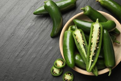 Photo of Ripe green jalapeno peppers on grey table, flat lay. Space for text