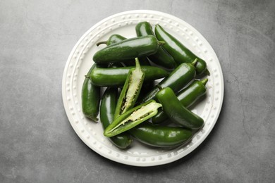Photo of Ripe green jalapeno peppers on grey table, top view
