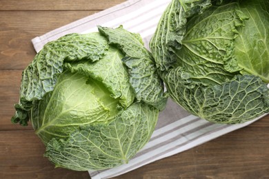 Photo of Fresh Savoy cabbages on wooden table, top view