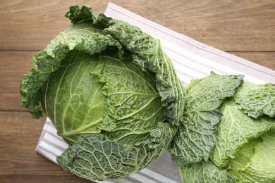Photo of Fresh Savoy cabbages on wooden table, top view
