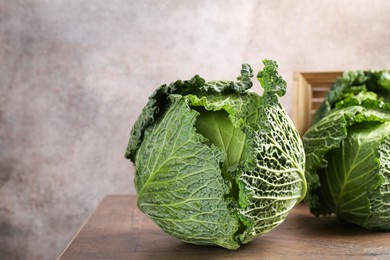 Photo of Fresh ripe Savoy cabbages on wooden table