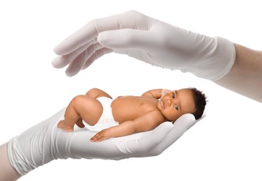 Image of In vitro fertilization (IVF). Doctor holding little baby in hand against white background