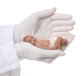 Image of In vitro fertilization (IVF). Doctor holding little baby in hand against white background