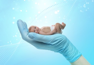 Image of In vitro fertilization (IVF). Cute little baby in doctor's hand against light blue background with DNA