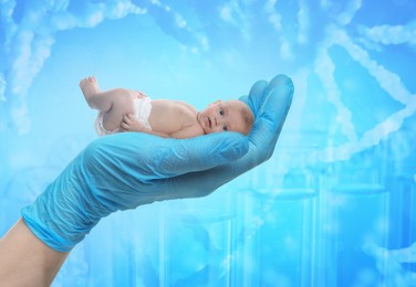 Image of In vitro fertilization (IVF). Cute little baby in doctor's hand against light blue background with test tubes and DNA