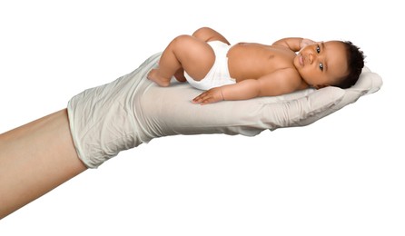 Image of In vitro fertilization (IVF). Cute little baby in doctor's hand against white background