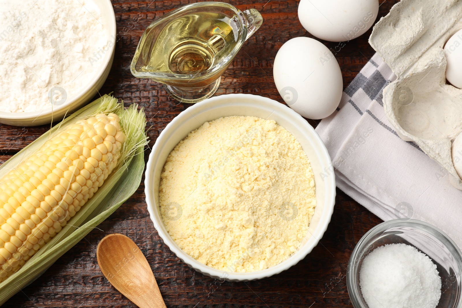 Photo of Different ingredients for corn bread on wooden table, flat lay