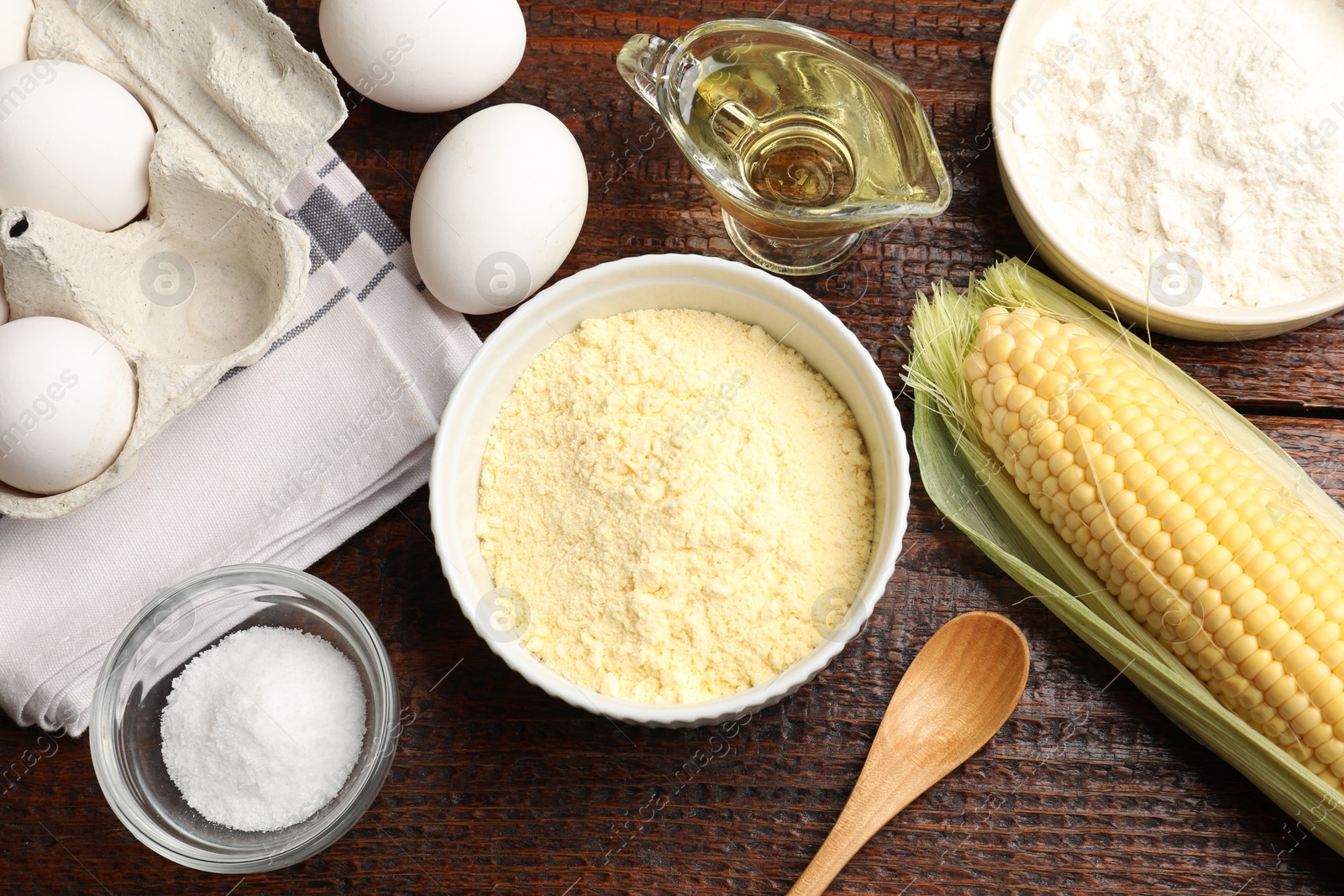 Photo of Different ingredients for corn bread on wooden table, flat lay