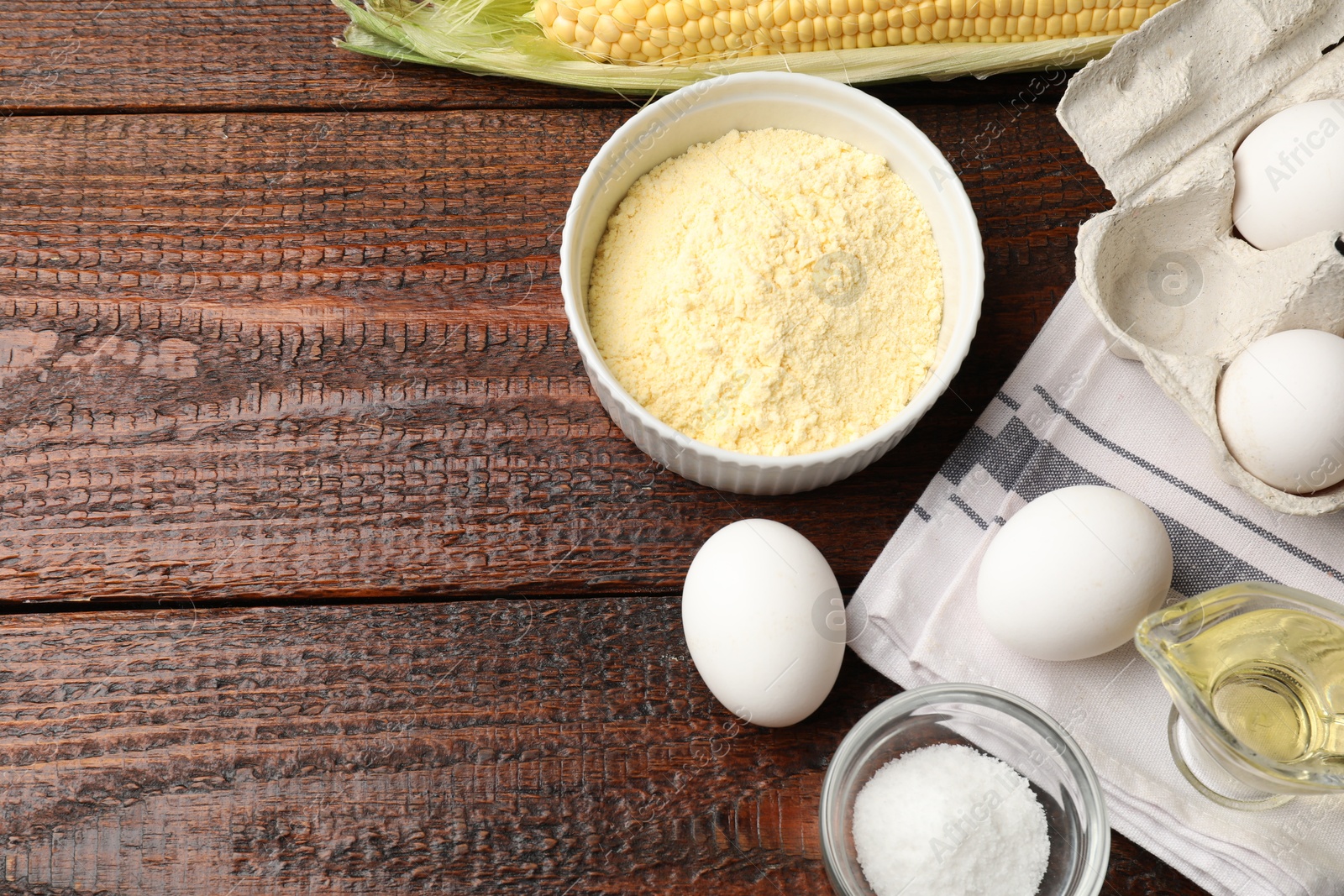 Different ingredients for corn bread on wooden table, flat lay. Space for text Photo of Different ingredients for corn bread on wooden table, flat lay. Space for text