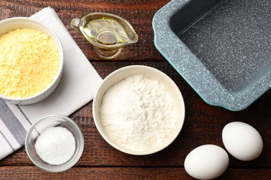 Photo of Different ingredients for corn bread and baking dish on wooden table, flat lay