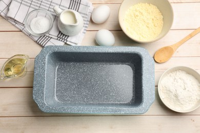 Photo of Baking dish and different ingredients for corn bread on light wooden table, flat lay. Space for text