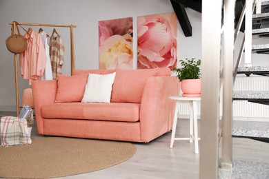 Image of Living room with coral color sofa and other furniture. Interior design