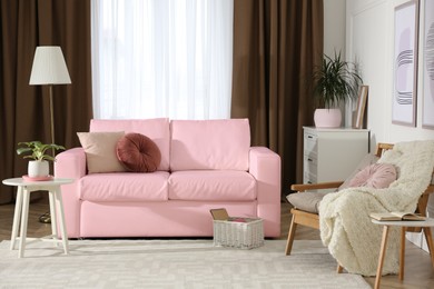Image of Living room with pink sofa and other furniture. Interior design