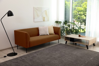 Image of Living room with brown sofa and other furniture. Interior design