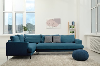 Image of Living room with blue sofa and other furniture. Interior design