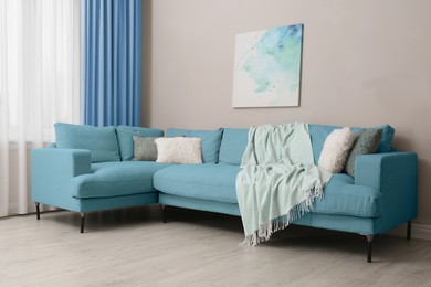 Image of Living room with light blue sofa and picture. Interior design