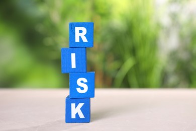 Image of Word Risk of blue wooden cubes with letters on table