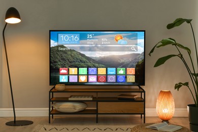 Image of TV set in room. Menu with icons and information on display