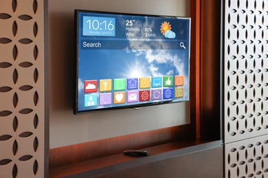 Image of TV set showing menu with icons and information on display in room