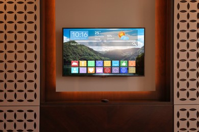 Image of TV set showing menu with icons and information on display in room