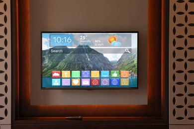 Image of TV set showing menu with icons and information on display in room