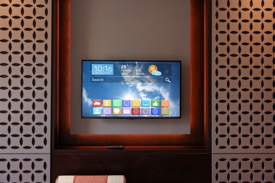 Image of TV set in room. Menu with icons and information on display