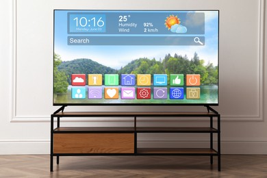 Image of TV set in room. Menu with icons and information on display