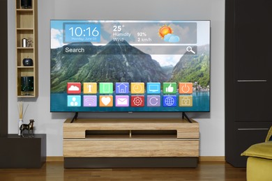 Image of TV set in room. Menu with icons and information on display