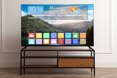 Image of TV set in room. Menu with icons and information on display
