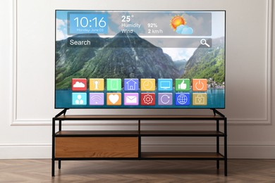 Image of TV set in room. Menu with icons and information on display