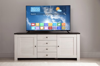 Image of TV set in room. Menu with icons and information on display