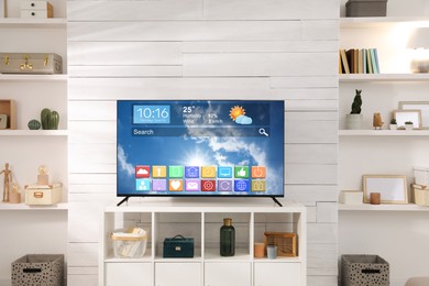Image of TV set in room. Menu with icons and information on display