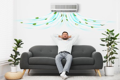 Image of Happy man resting on sofa in room with air conditioner