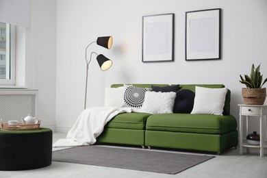 Image of Living room with green sofa and other furniture. Interior design
