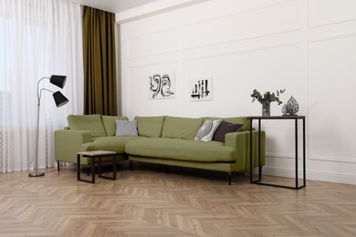 Image of Living room with olive color sofa and other furniture. Interior design