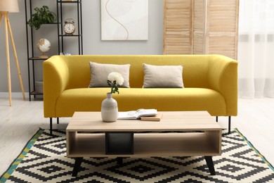 Image of Living room with yellow sofa and other furniture. Interior design